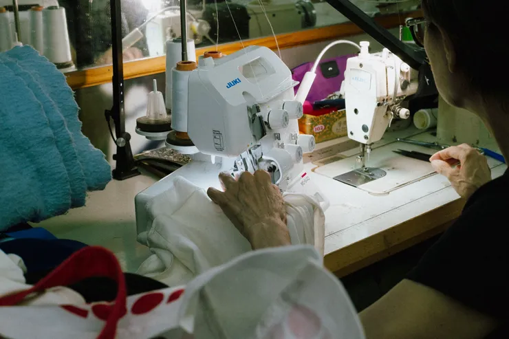 Tailor hemming a garment on a sewing machine